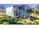 Two-story home with fenced pool, landscaping, and tropical plants at 13104 Via Cassia, Placida, FL 33946