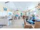 Open concept kitchen with white cabinets, granite countertops, and a breakfast bar at 13104 Via Cassia, Placida, FL 33946