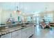 Modern kitchen with granite countertops and white cabinetry at 13104 Via Cassia, Placida, FL 33946