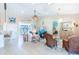 Bright living room featuring light wood floors and wicker furniture at 13104 Via Cassia, Placida, FL 33946