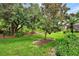 Landscaped backyard with lush greenery and mature trees at 13123 Preserve Ct, Port Charlotte, FL 33953