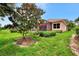 Landscaped backyard showcasing mature trees and home exterior at 13123 Preserve Ct, Port Charlotte, FL 33953