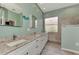 Spa-like bathroom with double sinks, granite countertops, and a walk-in shower at 13123 Preserve Ct, Port Charlotte, FL 33953