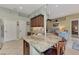 Granite kitchen island with seating and stainless steel appliances at 13123 Preserve Ct, Port Charlotte, FL 33953