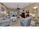 Living room with light blue sofas, ceiling fan, and view to pool at 13123 Preserve Ct, Port Charlotte, FL 33953