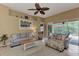 Living room with light blue sofas, wood coffee table, and sliding doors at 13123 Preserve Ct, Port Charlotte, FL 33953