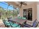 Covered patio with seating area and lush landscaping at 13123 Preserve Ct, Port Charlotte, FL 33953