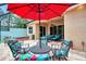 Outdoor patio with seating area, umbrella, and adjacent dining area at 13123 Preserve Ct, Port Charlotte, FL 33953