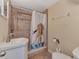 Bathroom with shower, toilet and small vanity at 138 Winson Ave, Englewood, FL 34223