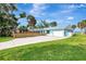 Waterfront home with large yard and concrete driveway at 138 Winson Ave, Englewood, FL 34223