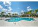 Inviting community pool with palm trees and lounge area at 1414 Backspin Dr, Englewood, FL 34223