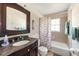 Bathroom with tub, shower, vanity, and seashell-themed curtain at 1531 Placida Rd # 1-204, Englewood, FL 34223