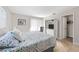 Main bedroom with floral bedding and en-suite bathroom at 1531 Placida Rd # 1-204, Englewood, FL 34223
