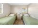 Two twin beds and a nightstand in a well-lit bedroom at 1531 Placida Rd # 1-204, Englewood, FL 34223