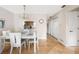 Dining area with white table and chairs, kitchen access, and a clock at 1531 Placida Rd # 1-204, Englewood, FL 34223