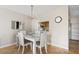 White dining set and chandelier in bright dining room at 1531 Placida Rd # 1-204, Englewood, FL 34223