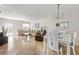 Bright dining room with white table and chairs, and a chandelier at 1531 Placida Rd # 1-204, Englewood, FL 34223