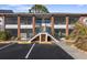 Two-story building with brick and white exterior, stairs, and parking at 1531 Placida Rd # 1-204, Englewood, FL 34223