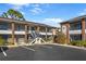 Front view of a two-story building with parking and landscaping at 1531 Placida Rd # 1-204, Englewood, FL 34223