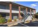 Condo building exterior showcasing a brick facade, stairs, and screened balconies at 1531 Placida Rd # 1-204, Englewood, FL 34223