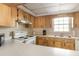 Kitchen boasts light wood cabinets, white appliances and a double sink at 1531 Placida Rd # 1-204, Englewood, FL 34223
