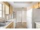 Kitchen with white appliances, wood cabinets, and access to pantry at 1531 Placida Rd # 1-204, Englewood, FL 34223