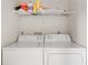 Laundry closet with washer and dryer, and overhead shelving at 1531 Placida Rd # 1-204, Englewood, FL 34223