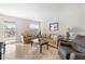 Bright living room with tiled floors, comfy sofas, and access to a balcony at 1531 Placida Rd # 1-204, Englewood, FL 34223