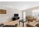 Spacious living room with tiled floors, comfortable seating, and a large TV at 1531 Placida Rd # 1-204, Englewood, FL 34223