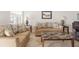 Living room with light beige sofas, a marble-top coffee table, and tile floors at 1531 Placida Rd # 1-204, Englewood, FL 34223