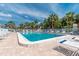 Inviting community pool with ample lounge chairs under sunny skies at 1531 Placida Rd # 1-204, Englewood, FL 34223