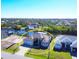 Aerial view of single-Gathering home on canal with lush landscaping at 15336 Lakeland Cir, Port Charlotte, FL 33981