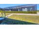 Spacious backyard with screened enclosure, extended patio, and canal access at 15336 Lakeland Cir, Port Charlotte, FL 33981