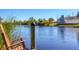 Relaxing waterfront view with wooden dock and chair at 15336 Lakeland Cir, Port Charlotte, FL 33981
