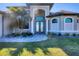 Inviting house exterior featuring a double door entry and landscaped yard at 15336 Lakeland Cir, Port Charlotte, FL 33981