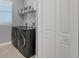 Laundry room with washer, dryer, and shelving at 15336 Lakeland Cir, Port Charlotte, FL 33981