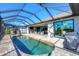 Resort-style pool with screened enclosure and outdoor kitchen at 15336 Lakeland Cir, Port Charlotte, FL 33981