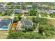 Stunning aerial view of a charming neighborhood featuring waterfront homes, lush landscaping, and private pools at 15375 Taurus Cir, Port Charlotte, FL 33981