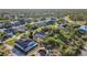 Aerial view showcasing a neighborhood with houses, canals, and lush green spaces at 15375 Taurus Cir, Port Charlotte, FL 33981