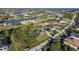 Aerial view of a house nestled amongst other homes near a canal at 15375 Taurus Cir, Port Charlotte, FL 33981