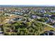 Wide aerial view of a coastal community with numerous houses and waterways at 15375 Taurus Cir, Port Charlotte, FL 33981