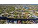 An aerial view of a large waterfront community with many houses and canals at 15375 Taurus Cir, Port Charlotte, FL 33981