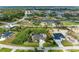 An aerial view of the property showcases lush landscaping, a large driveway, and waterfront access at 15375 Taurus Cir, Port Charlotte, FL 33981