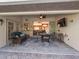 Relaxing back patio with seating area, dining table, and view of living room at 15375 Taurus Cir, Port Charlotte, FL 33981