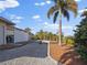 Landscaped backyard with gravel pathway, tropical plants, and a white fence at 15375 Taurus Cir, Port Charlotte, FL 33981