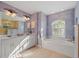 Spa-like bathroom with double sinks, a garden tub, and a separate shower at 15375 Taurus Cir, Port Charlotte, FL 33981