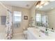 Bathroom with decorative seashell accents, shower with curtain, and vanity at 15375 Taurus Cir, Port Charlotte, FL 33981