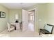 Bedroom featuring a desk, a ceiling fan, and a view into an adjoining room at 15375 Taurus Cir, Port Charlotte, FL 33981