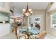 Cozy dining area with glass table, seating for six, and modern chandelier at 15375 Taurus Cir, Port Charlotte, FL 33981