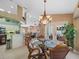 Charming dining room features a glass-top table and wicker chairs, near the kitchen at 15375 Taurus Cir, Port Charlotte, FL 33981